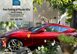a red car parked in front of a building at Les Anges Deluxe Avignon - Luxury Home - Exclusive Services & Tours in Avignon