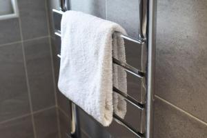 a towel hanging on a towel rack in a bathroom at Spacious 4-Bed Family House in Portsmouth +43 photos
