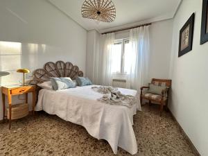 a bedroom with a bed and a chair and a window at CASA LUMERMA in Taboadela +50 photos
