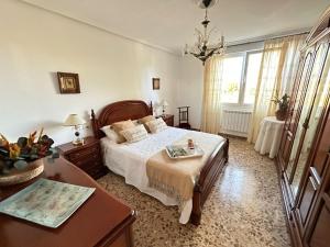 een slaapkamer met een bed, een dressoir en een tafel bij CASA LUMERMA in Taboadela