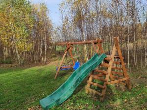 a playground with a slide and a ladder at Willa w Brzozach Sznurki Spokojna 1 - Chmielno, Kaszuby, dom, jezioro in Chmielno