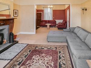 a living room with a couch and a fireplace at Victoria House By The Sea in Whitley Bay