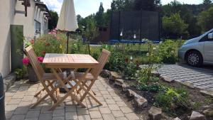 einen Holztisch und zwei Stühle im Garten in der Unterkunft Ferienapartment Ida in Lorch