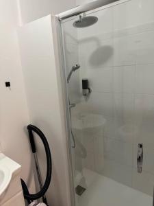 a bathroom with a glass shower with a sink at F2 à 500 m centre ville et gare - 1er étage in Soissons