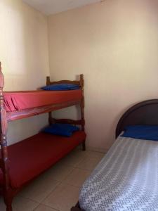 a bedroom with two bunk beds in a room at Casa 2 in Praia Grande