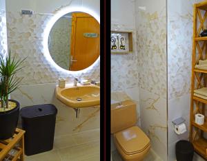 a bathroom with a sink and a toilet and a mirror at Piso en Candelaria con terraza, vistas al mar, aire acondicionado y garaje in Candelaria