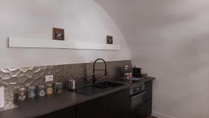 a kitchen with a sink and a counter top at Le Piccole Lune di Monti in Rome