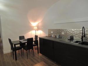 a kitchen with a table and chairs and a kitchen with a light at Le Piccole Lune di Monti in Rome