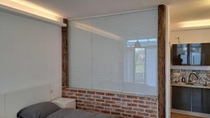 a bedroom with a window with blinds on it at Kara Ben Nemsi in Ilmmünster