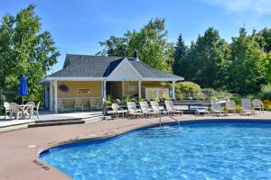 a house with a pool and chairs in front of it at Snowbridge in Blue Mountains