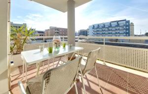 a white table and chairs on a balcony with a view at Nice Apartment In Moncofa Playa With Outdoor Swimming Pool in Moncófar