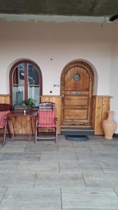 a room with a table and chairs and a wooden door at Hopfenalm in Ilmmünster