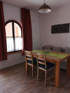 a dining room with a wooden table and chairs at Hopfenalm in Ilmmünster