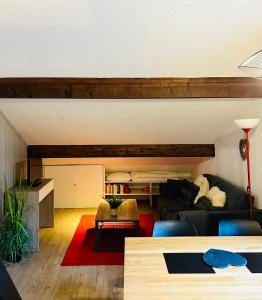 a living room with a couch and a table at Appartement Duplex Forclaz in Chamonix-Mont-Blanc