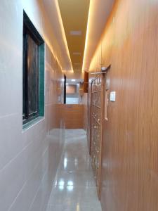 a hallway with wood paneling and a row of lockers at Kufa PG Dormitory in Mumbai