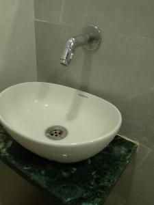 a white sink with a faucet on a counter at Kufa PG Dormitory in Mumbai