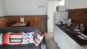 a kitchen with a couch and a sink in a kitchen at La Mansarde in Saint-Émilion