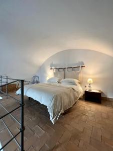 a bedroom with a large white bed in a room at Wine & Roses in Mattinata