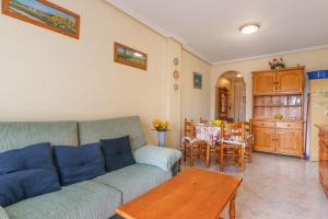 uma sala de estar com um sofá e uma mesa em 007 - Las Marismas 001 - comfortHOLIDAYS em Santa Pola