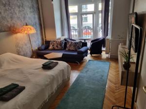 a living room with a bed and a couch at Apartment Vuksa in Novi Sad