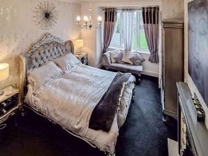 a bedroom with a large bed and a window at The Garden House in Folkestone