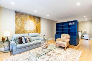 a living room with a couch and a chair at Colourful Studio Near Clapham Common! in London