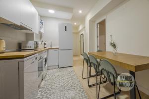 a kitchen with white appliances and a table and chairs at Cool Apt para 9pax en plena Plaza de Chueca in Madrid