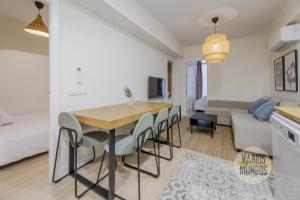 a dining room and living room with a table and chairs at Cool Apt para 9pax en plena Plaza de Chueca in Madrid
