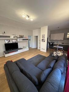 a living room with a large blue couch in a living room at Casa vento marino in Livorno