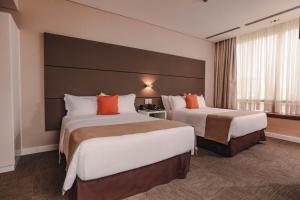 Krevet ili kreveti u jedinici u objektu Paseo La Galería Hotel & Suites