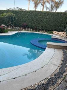 a swimming pool with blue water in a resort at Villa 141 in Sheikh Zayed