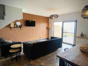 a living room with a couch and a table at Beachfront 3 bedroom house in Hentiesbaai