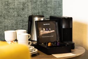 a coffee maker and a box with a picture of a hand at Hotel Osijek in Osijek