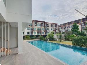 a swimming pool in front of a building at Jira Private cozy room near Suvarnabhumi Airport in Lat Krabang