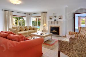 a living room with two couches and a fireplace at Jardim Secreto in Luz
