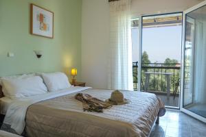 a bedroom with a bed with a hat on it at Aphrodite Studios in Kallithea Halkidikis
