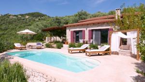 una piscina con sillas y una casa en Amapola Boutique Villas with Sea Access - Phos, en Sivota