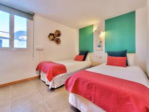 two beds in a room with green and white at Attic 10 by Grupo Compostelana in Puerto de la Cruz