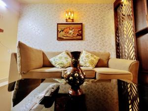 a living room with a couch and a vase on a table at Chic 2BR Haven in the midst of greenery. in Mangalore