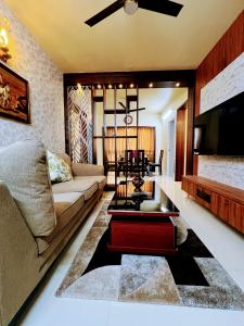a living room with a couch and a coffee table at Chic 2BR Haven in the midst of greenery. in Mangalore
