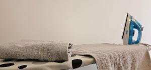 a laptop sitting on top of a table with a blanket at Superb 1 bedroom in the best zone of the city. in Ferizaj