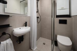La salle de bains est pourvue de toilettes, d'un lavabo et d'une douche. dans l'établissement Wohnung 'The Cove' HBF/Messe/ÖVB Arena/City, à Brême
