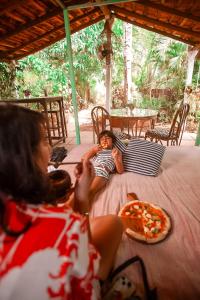 a young child laying on a table with a pizza at Wigwam in Mandrem