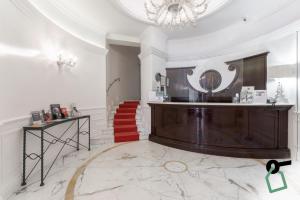 a lobby with a staircase and a mirror on the wall at HOTIDAY Hotel Roma Porta Pia in Rome