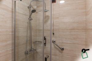 a shower in a bathroom with a glass door at HOTIDAY Hotel Roma Porta Pia in Rome