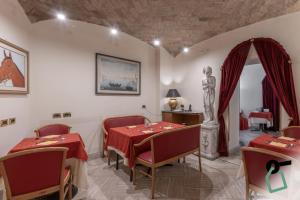 a dining room with a table and a statue at HOTIDAY Room Collection - Roma Porta Pia in Rome