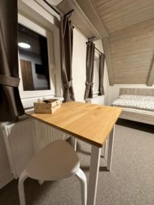 a table and a chair in a tiny house at Apartmány VESNA in Nova Ves nad Nisou