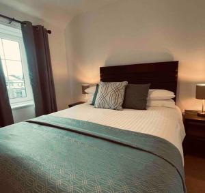 a bedroom with a large bed and a window at Wonderful Town House in Killarney