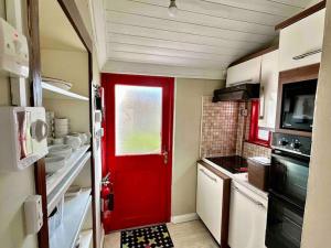 a red door in a small kitchen with a red at Wonderful Town House where Irelands current President Connolly has stayed while visiting town in Killarney
