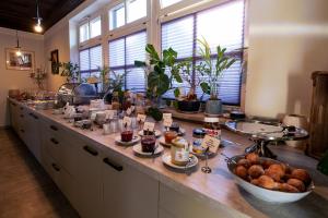 a kitchen counter with a bunch of food on it at Landhotel Rose am Plauer See garni in Plau am See